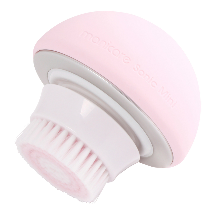 Side profile of Manicare Sonic Mini rechargeable facial cleansing brush with ergonomic handle and waterproof brush head