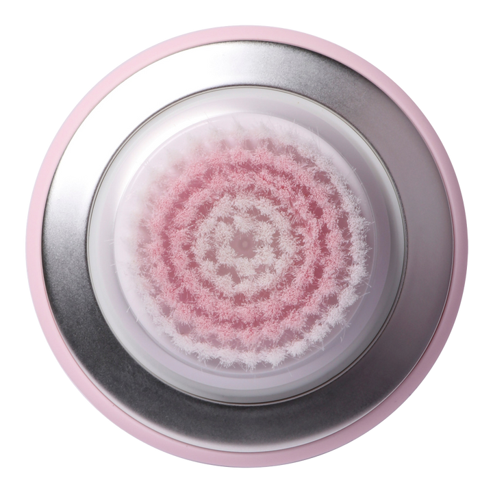 Bottom view of Manicare Sonic Mini facial brush showing waterproof base, brush texture, and ergonomic handle design