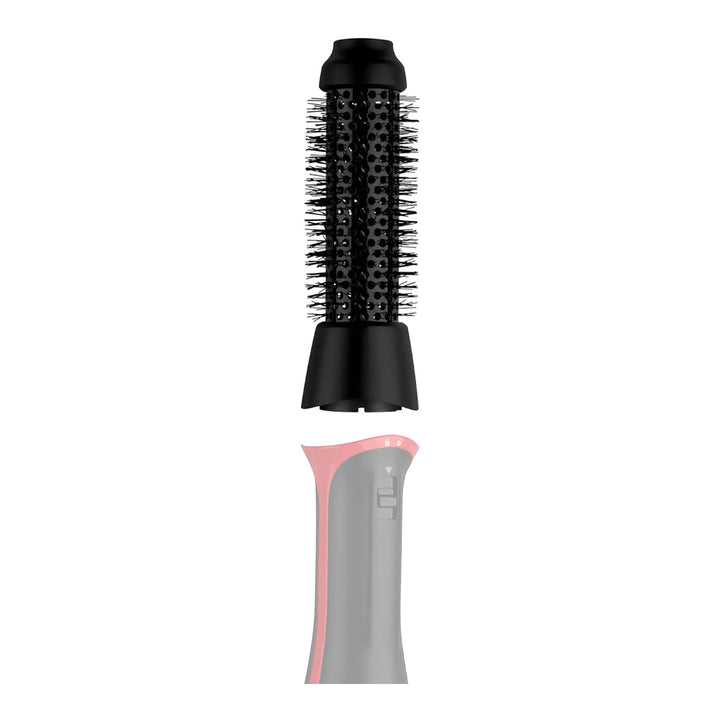 Closeup of Revlon Volumiser PLUS 38mm round brush being attached to power head, showing interchangeable design and secure click fit